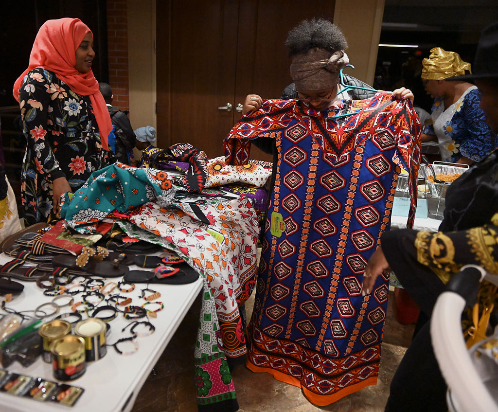 Zayana Hamid, left, helps Caroline Wanjiru choose a dress